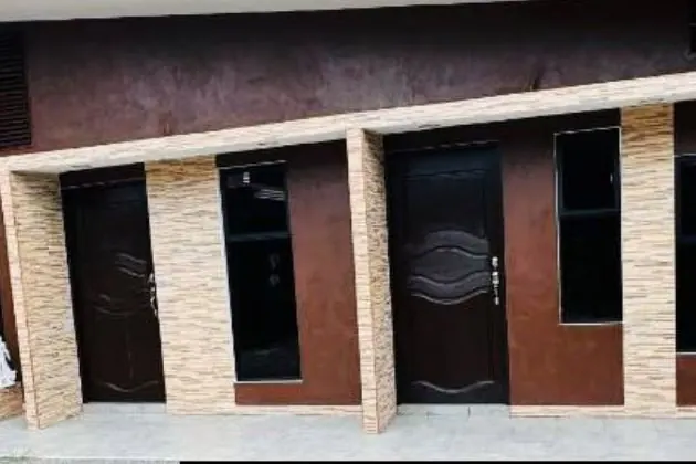 Fachada de apartamentos café con columnas de piedra clara